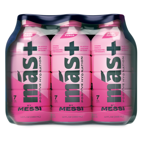 12-pack of más+ by Messi hydration drinks. The pink bottles feature bold black text that reads 'más+ Positive Hydration' and include key highlights such as 7 calories per bottle, no artificial sweeteners, and added electrolytes and antioxidants. Each bottle contains 12 fl oz (355 mL).