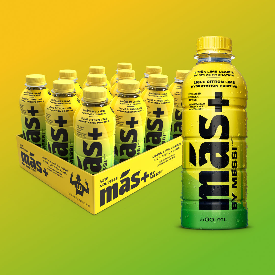 A box of six yellow and green Más+ by Messi bottles labeled 'Limon-Lime League' with one bottle prominently displayed in the front