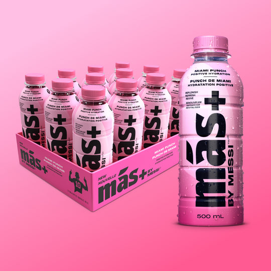 A box of six pink Más+ by Messi bottles labeled 'Miami Punch' with one bottle prominently displayed in the front