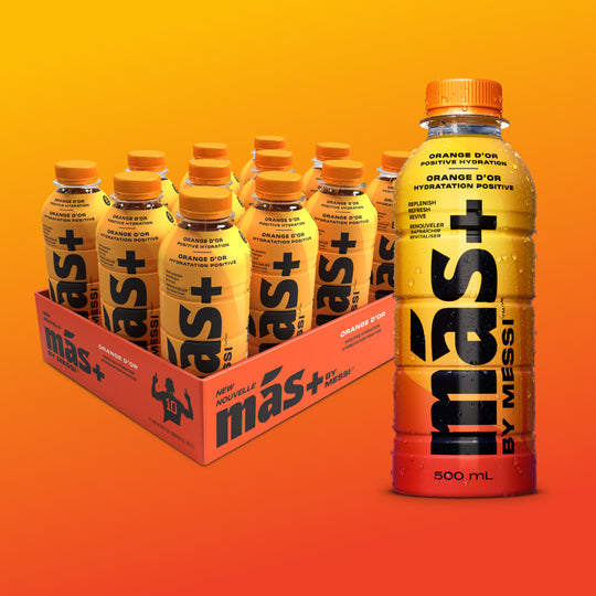A box of six orange Más+ by Messi bottles labeled 'Orange D'Or' with one bottle prominently displayed in the front
