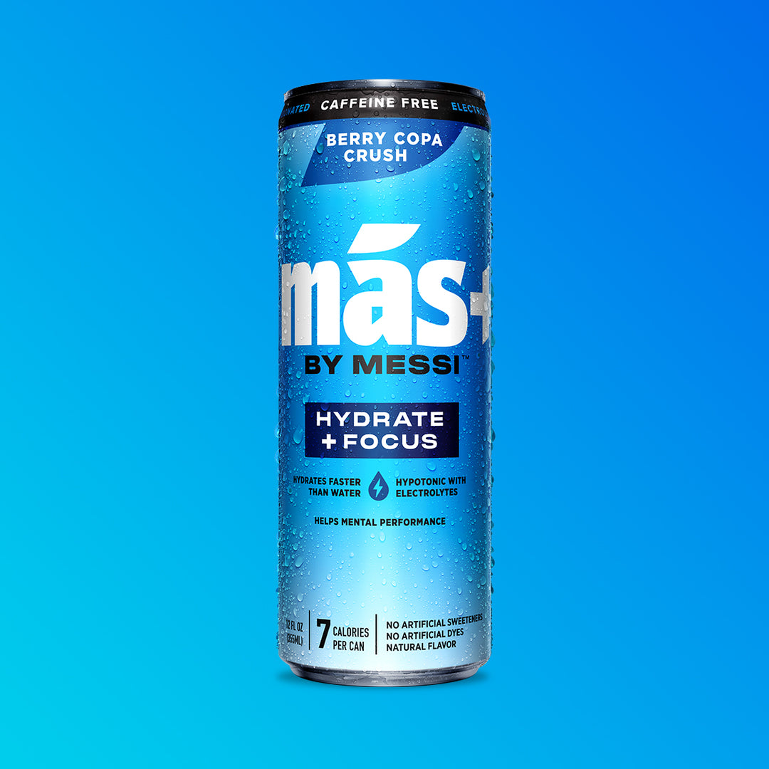 A single, condensation-covered can of Más by Messi Berry Copa Crush flavored, caffeine-free sports drink.