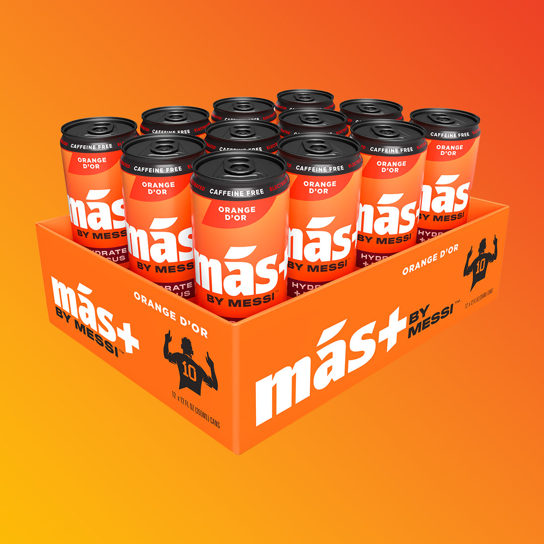 A 12-pack of MÁS+ by Messi 'Orange d'Or' hydration drink cans in an orange box, set against an orange and yellow gradient background