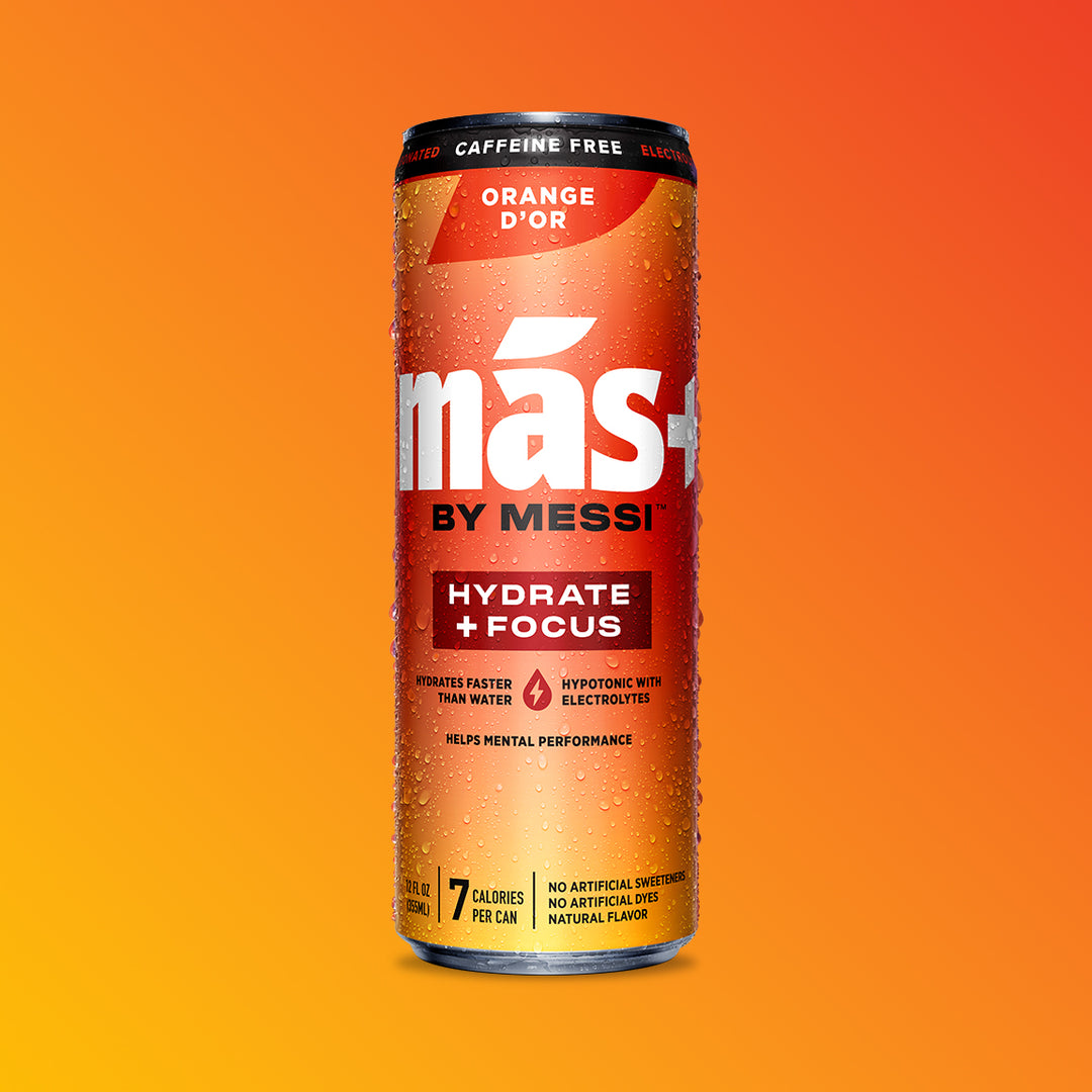 A single, condensation-covered can of MÁS+ by Messi 'Orange d'Or' hydration drink against an orange-yellow background.